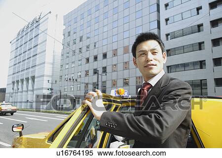 Stock Photography - Man is stepping out of car, portrait. Fotosearch