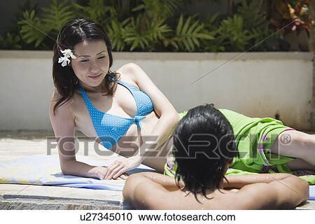 A man in pool and woman looking at him View Large Photo Image Stock Image - A man in pool and woman looking at him. Fotosearch