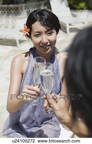 Stock Image - A woman toasting wineglass. Fotosearch
