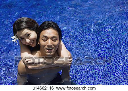 A young coupe in pool View Large Photo Image Stock Photograph - A young coupe in pool. Fotosearch
