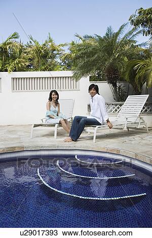 A young couple sitting on deckchairs View Large Photo Image Stock Image - A young couple sitting on deckchairs. Fotosearch