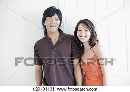 A young couple smiling View Large Photo Image Stock Image - A young couple smiling. Fotosearch