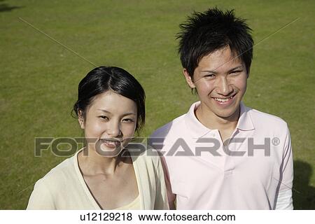 Elevated view of a young couple smiling View Large Photo Image Stock Photo - Elevated view of a young couple smiling. Fotosearch