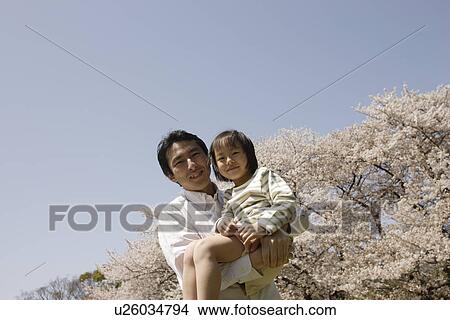 Picture - Portrait of a father carrying daughter. Fotosearch