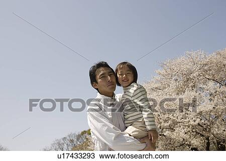 Portrait of a father carrying daughter View Large Photo Image Stock Image - Portrait of a father carrying daughter. Fotosearch