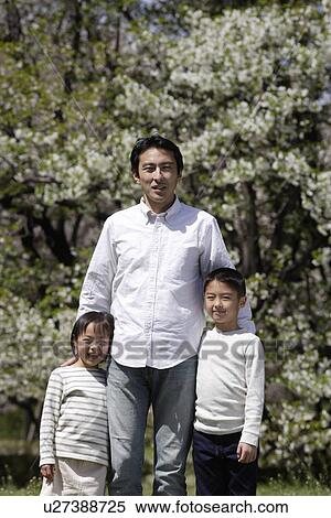 Portrait of a man standing with son and daughter View Large Photo Image Stock Photography - Portrait of a man standing with son and daughter. Fotosearch