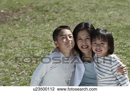 Portrait of a mother and children sitting in garden View Large Photo Image Stock Image - Portrait of a mother and children sitting in garden. Fotosearch