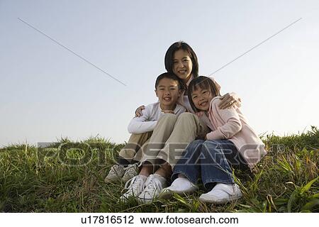 Stock Image - Portrait of a mother embracing her children. Fotosearch