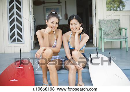 Stock Photo - Portrait young women sitting on stairs. Fotosearch