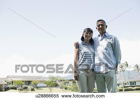 Stock Photography - View of a couple standing together. Fotosearch