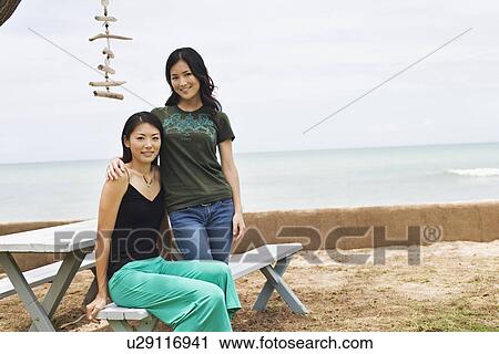 View of young women together smiling View Large Photo Image Stock Image - View of young women together smiling. Fotosearch