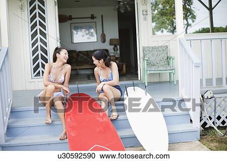 Young women sitting on stairs laughing View Large Photo Image Stock Image - Young women sitting on stairs laughing. Fotosearch
