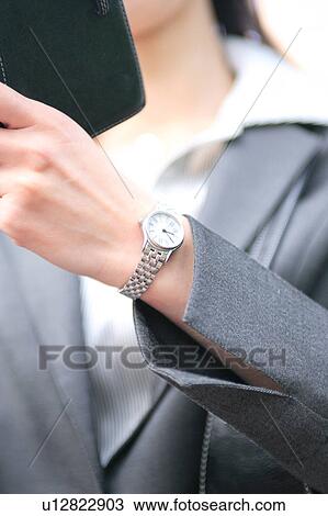 A young businesswoman checking schedule, close-up View Large Photo Image Stock Image - A young businesswoman checking schedule, close-up. Fotosearch