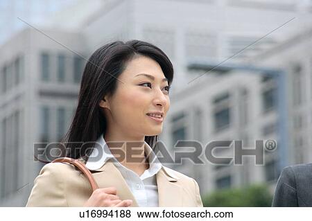 A young businesswoman smiling View Large Photo Image Stock Photo - A young businesswoman smiling. Fotosearch