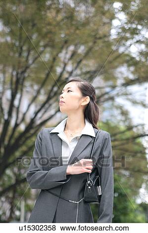 A young businesswoman standing View Large Photo Image Stock Photo - A young businesswoman standing. Fotosearch
