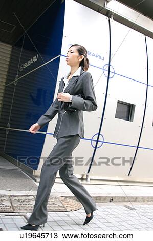 A young businesswoman walking View Large Photo Image Stock Image - A young businesswoman walking. Fotosearch