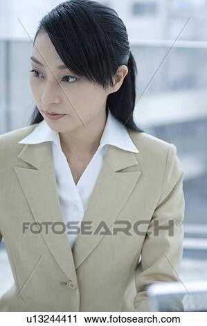 A young woman working in office View Large Photo Image Stock Image - A young woman working in office. Fotosearch