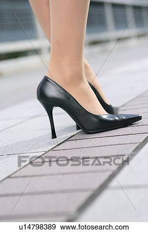 Close-up of a young woman's feet in heels View Large Photo Image Stock Photo - Close-up of a young woman's feet in heels. Fotosearch