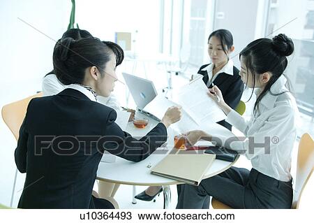 Four young women having meeting in office View Large Photo Image Stock Image - Four young women having meeting in office. Fotosearch
