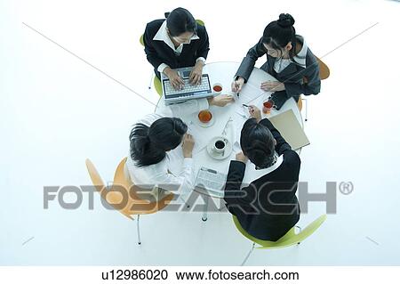 Four young women having meeting in office View Large Photo Image Stock Image - Four young women having meeting in office. Fotosearch