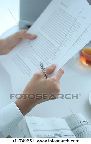 Stock Image - Hand of a young woman working, close-up. Fotosearch