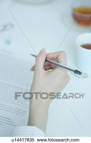 Stock Photography - Hand of a young woman working. Fotosearch