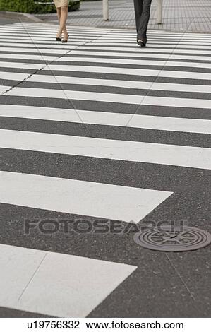 Stock Image - Low section of two young businesswomen walking. Fotosearch