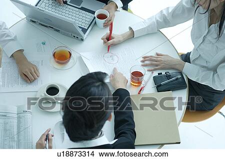 Small group of young women having meeting in office View Large Photo Image Picture - Small group of young women having meeting in office. Fotosearch