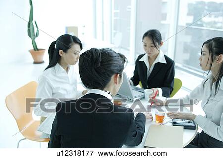 Small group of young women having meeting in office, close-up View Large Photo Image Stock Photo - Small group of young women having meeting in office, close-up. Fotosearch