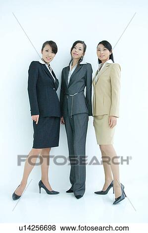 Three young businesswomen standing, portrait View Large Photo Image Stock Photo - Three young businesswomen standing, portrait. Fotosearch
