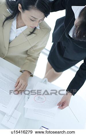 Two young businesswomen having discussion View Large Photo Image Stock Photo - Two young businesswomen having discussion. Fotosearch