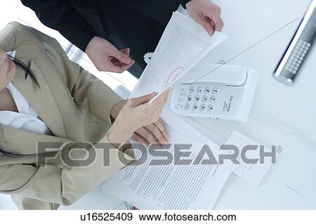 Stock Photo - Two young businesswomen having discussion. Fotosearch
