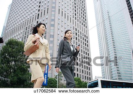 Two young businesswomen walking View Large Photo Image Picture - Two young businesswomen walking. Fotosearch