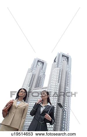 Two young businesswomen walking View Large Photo Image Stock Image - Two young businesswomen walking. Fotosearch