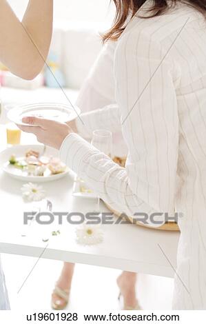 A woman is serving food at party View Large Photo Image Stock Photo - A woman is serving food at party. Fotosearch