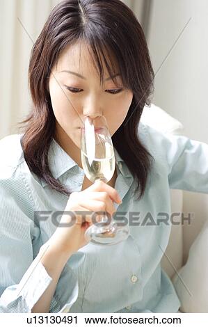 A young woman drinking a glass of champagne View Large Photo Image Stock Image - A young woman drinking a glass of champagne. Fotosearch