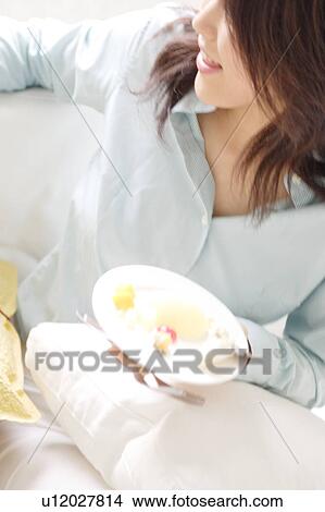 Picture - A young woman holding a plate. Fotosearch