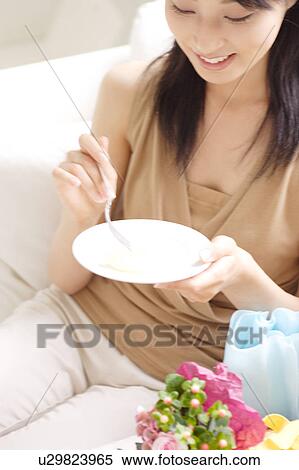 A young woman holding a plate View Large Photo Image Stock Photography - A young woman holding a plate. Fotosearch