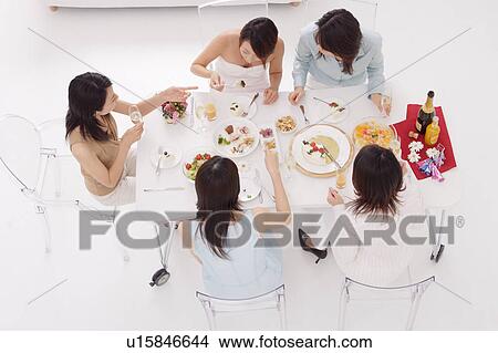 Picture - Five young women having home party, high angle view. Fotosearch