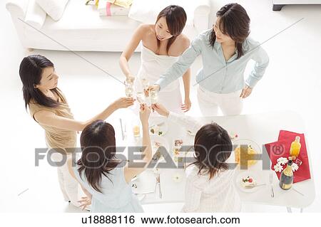 Stock Photograph - Five young women toasting with glasses of champagne. Fotosearch