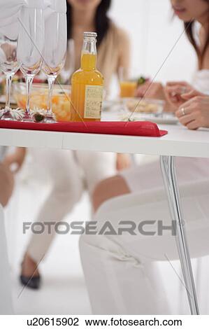 Stock Image - Small group of people having home party. Fotosearch