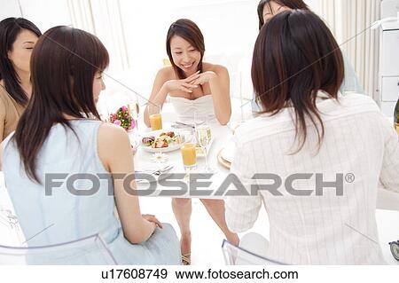 Small group of people having home party View Large Photo Image Stock Photo - Small group of people having home party. Fotosearch