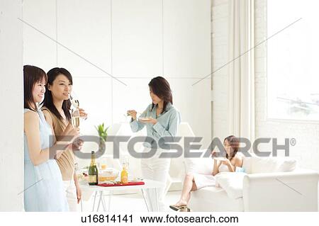 Small group of young women enjoying party at home View Large Photo Image Stock Image - Small group of young women enjoying party at home. Fotosearch