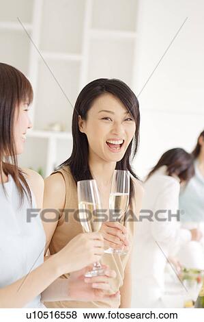 Stock Photo - Small group of young women enjoying party at home. Fotosearch
