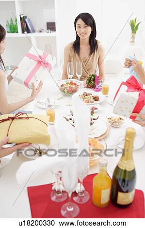 Small group of young women having party at home View Large Photo Image Stock Image - Small group of young women having party at home. Fotosearch