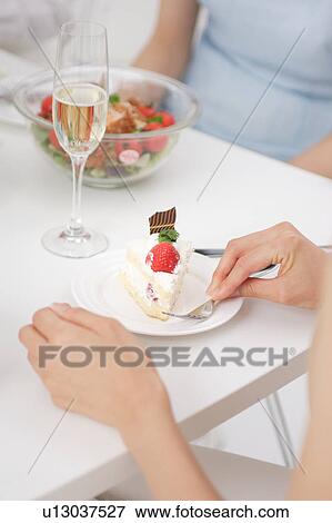 Stock Photo - Two young women at table. Fotosearch