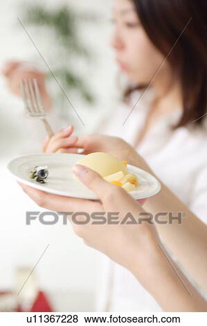 Stock Photo - Young women eating, close-up. Fotosearch