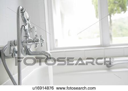 Close-up of tap running water into bath View Large Photo Image Stock Photograph - Close-up of tap running water into bath. Fotosearch