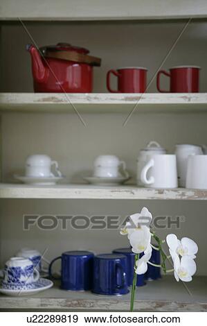 Stock Photo - Cups and saucers on shelf. Fotosearch