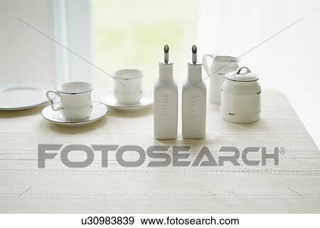 Cups and saucers on table View Large Photo Image Stock Photo - Cups and saucers on table. Fotosearch
